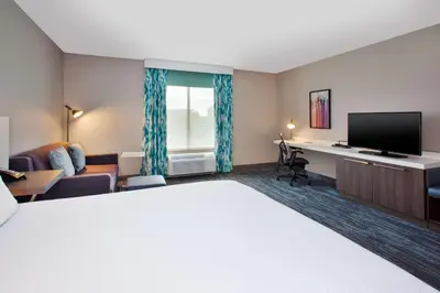 a hotel room with a bed and a desk at Hilton Garden Inn Dayton/ Beavercreek in Beavercreek