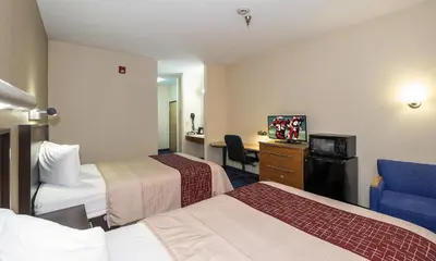 a hotel room with two beds and a desk at Red Roof Inn Jackson, OH in Jackson