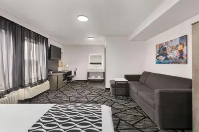 a living room with a couch and a desk at La Quinta by Wyndham Cleveland Airport West in North Olmsted