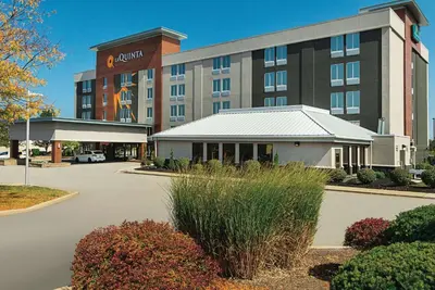 a hotel with a parking lot in front of it at La Quinta by Wyndham Cleveland Airport West in North Olmsted