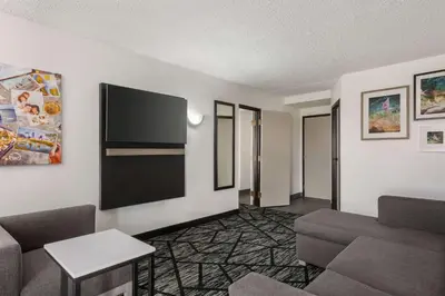 a living room with a couch and a flat screen tv at La Quinta by Wyndham Cleveland Airport West in North Olmsted