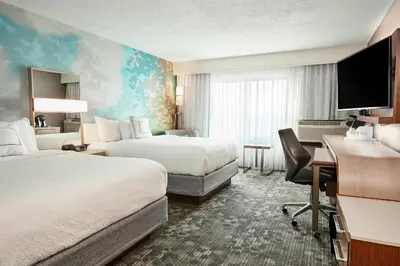 a hotel room with two beds and a desk at Courtyard Cincinnati Airport South/Florence in Florence