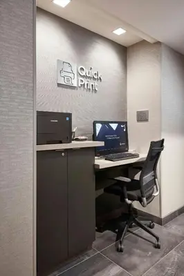 an office cubicle with a desk with a computer on it at Courtyard Cincinnati Airport South/Florence in Florence