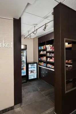 a store aisle with a refrigerator and shelves with food at Courtyard Cincinnati Airport South/Florence in Florence
