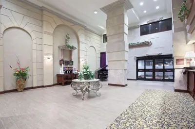a lobby with a table in the middle of a building at Hampton Inn Bowling Green in Bowling Green