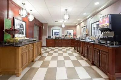 a restaurant with a food counter in a cafeteria at Hampton Inn Bowling Green in Bowling Green