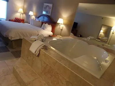 a bathroom with a large tub in a hotel room at Hampton Inn Bowling Green in Bowling Green