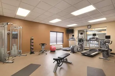 a gym with several exercise equipment in a room at Hilton Garden Inn Akron-Canton Airport in North Canton