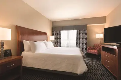 a hotel room with a bed and a television at Hilton Garden Inn Akron-Canton Airport in North Canton