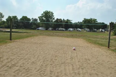 a soccer ball sitting in the sand next to a goal at Wilmington Camping Resort in Wilmington