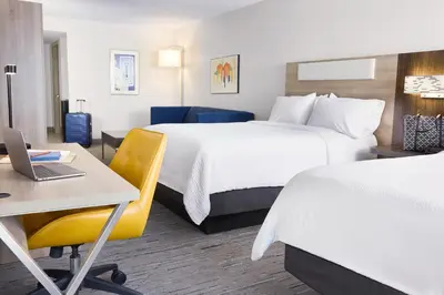 a hotel room with two beds and a desk and a laptop at Holiday Inn Express Lexington - Horse Park Area by IHG in Lexington