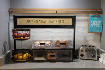 a bakery with a shelf with different types of pastries at Hampton Inn Kent/Akron Area in Kent