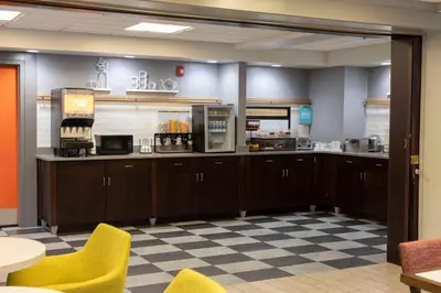 a kitchen with wooden cabinets and a checkered floor at Hampton Inn Kent/Akron Area in Kent