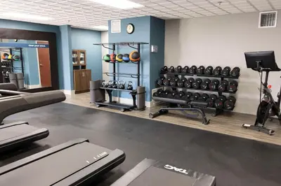 a gym with dumbbells and weights in a room at Hampton Inn Kent/Akron Area in Kent