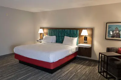 a hotel room with a bed and a couch at Hampton Inn Kent/Akron Area in Kent
