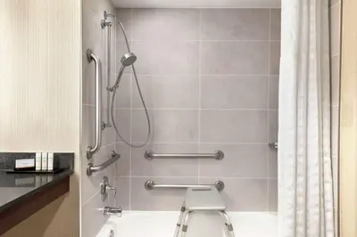 a bathroom with a shower with a toilet at Embassy Suites by Hilton Cleveland Rockside in Independence