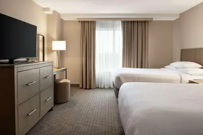 a hotel room with two beds and a flat screen tv at Embassy Suites by Hilton Cleveland Rockside in Independence