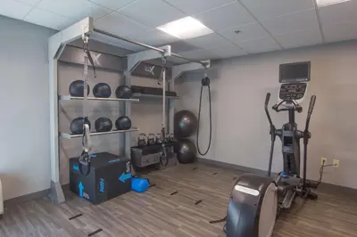 a room with a gym with bikes and weights at Hampton Inn Medina in Medina
