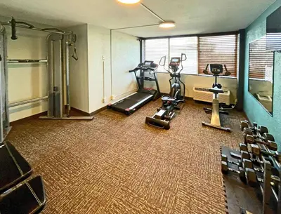 a gym with a treadmill and ellipticals in a room at Quality Inn & Suites Cincinnati Downtown Area in Cincinnati