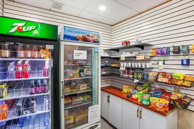 a grocery store aisle with a refrigerator and food at Quality Inn & Suites Cincinnati Downtown Area in Cincinnati