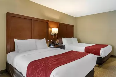 two beds in a hotel room with two at Comfort Suites Mason near Kings Island in Mason