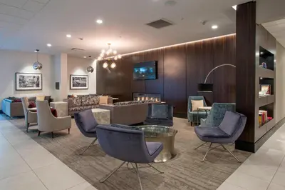 a lobby with a waiting room with chairs and a table at Residence Inn by Marriott Cincinnati Midtown/Rookwood in Cincinnati