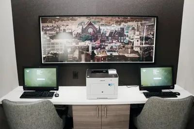 a desk with two laptops and a printer on it at Residence Inn by Marriott Cincinnati Midtown/Rookwood in Cincinnati