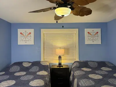 a bedroom with two beds and a ceiling fan at Put-in-Bay Waterfront Condo #103 in Put-in-Bay