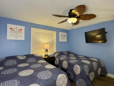 a bedroom with two beds and a ceiling fan at Put-in-Bay Waterfront Condo #103 in Put-in-Bay