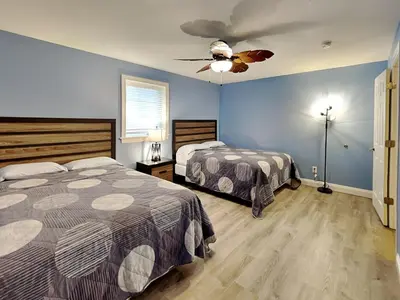 a bedroom with two beds and a ceiling fan at Put-In-Bay Waterfront Condo #108 in Put-in-Bay