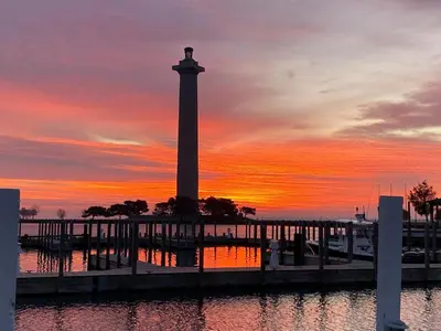 a clock tower with a sunset in the background at Put-In-Bay Waterfront Condo #108 in Put-in-Bay