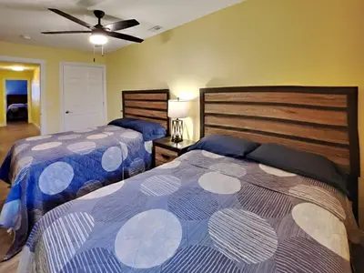 a bedroom with two beds and a ceiling fan at Put-In-Bay Waterfront Condo #108 in Put-in-Bay
