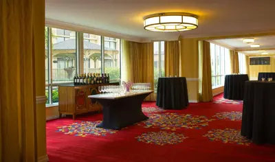 a wine tasting room with a table and windows at Wyndham Cleveland Airport in Cleveland