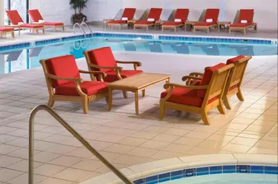 a row of chairs and a pool with red chairs at Wyndham Cleveland Airport in Cleveland