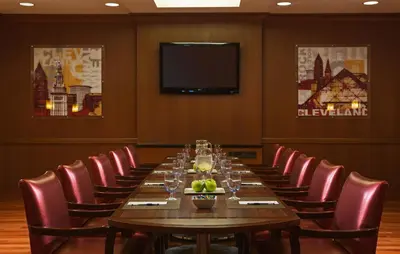 a conference room with a long table and chairs at Wyndham Cleveland Airport in Cleveland