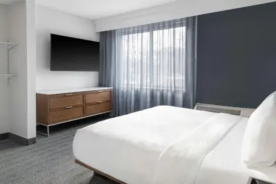 a hotel room with a bed and a television at Courtyard Cleveland Airport South in Middleburg Heights