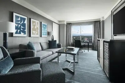 a living room with a couch and a tv at The Ritz-Carlton, Cleveland in Cleveland