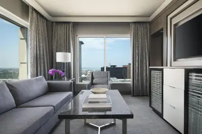 a living room with a couch and a tv at The Ritz-Carlton, Cleveland in Cleveland