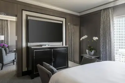 a hotel room with a large bed and a flat screen tv at The Ritz-Carlton, Cleveland in Cleveland