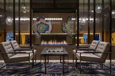a lobby with two chairs and a fireplace at The Ritz-Carlton, Cleveland in Cleveland