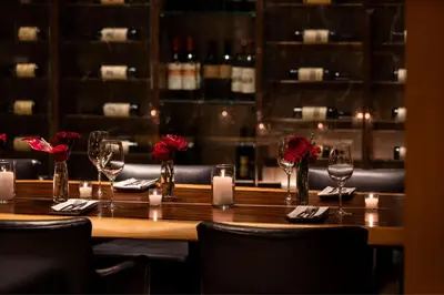 a table in a restaurant with wine glasses and roses at The Ritz-Carlton, Cleveland in Cleveland