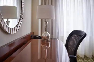 a table with a lamp and a glass bottle on it at Cleveland Marriott Downtown at Key Tower in Cleveland