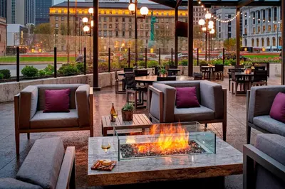 a patio with a fire pit and chairs and tables at Cleveland Marriott Downtown at Key Tower in Cleveland