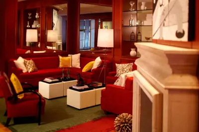 a living room with red couches and yellow pillows at Renaissance Columbus Downtown Hotel in Columbus