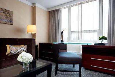 a hotel room with a desk and a chair and a room at Renaissance Columbus Downtown Hotel in Columbus