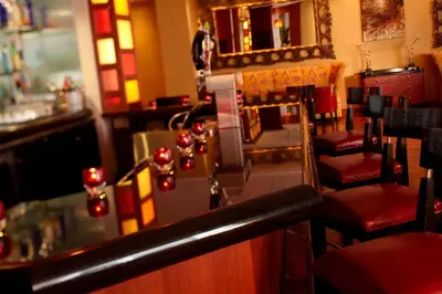 a bar with chairs and a counter with lights at Renaissance Columbus Downtown Hotel in Columbus