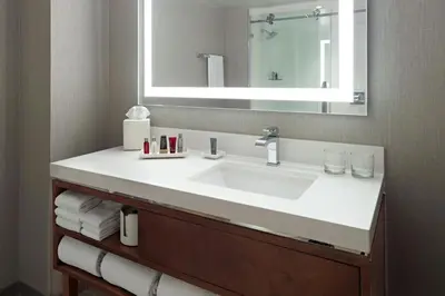 a bathroom with a white sink and a mirror at Marriott at the University of Dayton in Dayton