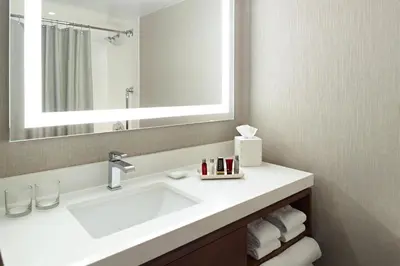 a bathroom with a sink and a mirror at Marriott at the University of Dayton in Dayton