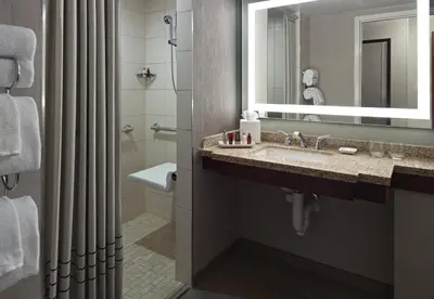 a bathroom with a sink and a mirror at Marriott at the University of Dayton in Dayton