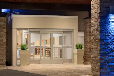an entrance to a building with two potted plants at Holiday Inn Express & Suites - Cincinnati South - Wilder by IHG in Wilder